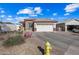 One-story house with a two-car garage and landscaped yard at 319 S 227Th Ct, Buckeye, AZ 85326