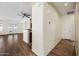 Bright hallway with wood flooring leading to living room and kitchen at 319 S 227Th Ct, Buckeye, AZ 85326