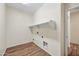 Laundry room with built-in shelving and wood flooring at 319 S 227Th Ct, Buckeye, AZ 85326
