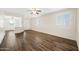 Bright living room with hardwood floors and plantation shutters at 319 S 227Th Ct, Buckeye, AZ 85326