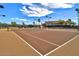 Well-maintained community tennis court ready for a friendly match under the sunny sky at 319 S 227Th Ct, Buckeye, AZ 85326