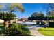 Scenic common area showcasing lush greenery, walking paths, and serene seating areas under a clear sky at 3301 S Goldfield Rd # 3038, Apache Junction, AZ 85119