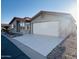 Single-story home with a red tile roof, two-car garage, and a well-maintained driveway at 3301 S Goldfield Rd # 3038, Apache Junction, AZ 85119
