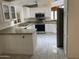 Modern kitchen with white cabinets, updated appliances, and an open floor plan at 3301 S Goldfield Rd # 3038, Apache Junction, AZ 85119