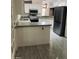 Open kitchen featuring white cabinets, stainless steel appliances, and an open serving bar at 3301 S Goldfield Rd # 3038, Apache Junction, AZ 85119
