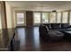 Well-lit living room featuring hardwood floors, an oversized sofa, and multiple windows at 3301 S Goldfield Rd # 3038, Apache Junction, AZ 85119