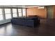 Spacious living room with dark laminate flooring and modern sofa at 3301 S Goldfield Rd # 3038, Apache Junction, AZ 85119