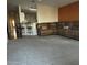 Open living room featuring a view of the kitchen and a comfortable leather sofa at 3301 S Goldfield Rd # 3038, Apache Junction, AZ 85119