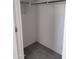 Walk-in closet with a hanging rod and grey carpet at 36061 W Santa Clara Ave, Maricopa, AZ 85138