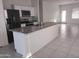 Modern kitchen with stainless steel appliances and granite countertops at 36061 W Santa Clara Ave, Maricopa, AZ 85138