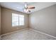 Bedroom with tile flooring and a window with blinds at 36521 W Padilla St, Maricopa, AZ 85138