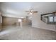 Open living room, tile floors, and view of kitchen and stairs at 36521 W Padilla St, Maricopa, AZ 85138