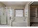 Well-appointed bathroom with a glass-enclosed shower, a soaking tub, and a view from the window at 4275 E Amarillo Dr, San Tan Valley, AZ 85140