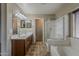 Well-lit bathroom featuring a double sink vanity, glass shower, and separate bathtub for a luxurious experience at 4275 E Amarillo Dr, San Tan Valley, AZ 85140