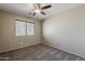 Bright bedroom with a ceiling fan, window, and soft carpeting for a peaceful and cozy space at 4275 E Amarillo Dr, San Tan Valley, AZ 85140