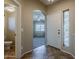 Bright entryway with tile floors, adjacent to a sidelight window and views into the living room and a half bath at 4275 E Amarillo Dr, San Tan Valley, AZ 85140