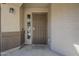 Close up of the front door featuring a storm door, sidelight window, and a 'Welcome to Our Home' doormat at 4275 E Amarillo Dr, San Tan Valley, AZ 85140