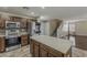 Open kitchen concept next to a staircase with stainless appliances and an island at 4275 E Amarillo Dr, San Tan Valley, AZ 85140