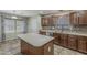 Kitchen featuring custom cabinets, an island, stainless steel appliances and tile backsplash at 4275 E Amarillo Dr, San Tan Valley, AZ 85140