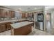 Spacious kitchen with an island, stainless steel appliances, tile backsplash, and ample counter space at 4275 E Amarillo Dr, San Tan Valley, AZ 85140