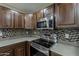 Elegant kitchen featuring stainless steel appliances and a mosaic tile backsplash at 4275 E Amarillo Dr, San Tan Valley, AZ 85140