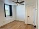 Bright bedroom featuring wood-look flooring, natural light from the window, and a modern ceiling fan at 5012 E Blanche Dr, Scottsdale, AZ 85254