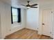 Bright bedroom features a ceiling fan, a large window, and neutral walls at 5012 E Blanche Dr, Scottsdale, AZ 85254