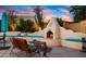 Charming outdoor fireplace with seating and landscaping at 5012 E Blanche Dr, Scottsdale, AZ 85254