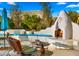 Charming outdoor fireplace with built-in seating area at 5012 E Blanche Dr, Scottsdale, AZ 85254