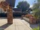 Well-maintained front yard with mature plants, brick elements, and a concrete patio at 5012 E Blanche Dr, Scottsdale, AZ 85254