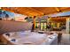 Luxurious hot tub under a pergola with string lights at 5012 E Blanche Dr, Scottsdale, AZ 85254