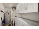 Functional laundry room with cabinets and utility sink at 5012 E Blanche Dr, Scottsdale, AZ 85254