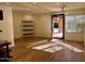 Spacious living room with wood floors, modern ceiling fan, and sunlit window at 5012 E Blanche Dr, Scottsdale, AZ 85254