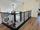 Open-concept loft with railing overlooking the lower level, hardwood floors and door to a bedroom at 5012 E Blanche Dr, Scottsdale, AZ 85254