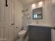 Contemporary bathroom with a gray vanity, marble-style flooring, and accent shelves at 5301 W Cambridge Ave, Phoenix, AZ 85035