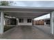 Attached carport and paved driveway, exterior stone accents, enhancing the home's curb appeal at 5301 W Cambridge Ave, Phoenix, AZ 85035