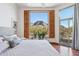 Main bedroom boasts a stunning mountain view, large window with wooden shutters, and tiled floors at 5341 E Windsong St, Apache Junction, AZ 85119