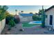 Relaxing backyard oasis with a sparkling pool, artificial turf, and desert landscaping at 5345 E Evans Dr, Scottsdale, AZ 85254