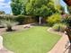 Landscaped backyard with artificial turf and mature trees at 5345 E Evans Dr, Scottsdale, AZ 85254