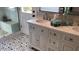 Spa-like bathroom with double vanity, marble counters, and patterned tile floor at 5345 E Evans Dr, Scottsdale, AZ 85254