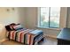 Cozy bedroom with striped bedding and large window at 5345 E Evans Dr, Scottsdale, AZ 85254