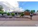 Single-story home with desert landscaping and a two-car garage at 5345 E Evans Dr, Scottsdale, AZ 85254