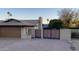 Two-car garage with modern wood gate and brick facade at 5345 E Evans Dr, Scottsdale, AZ 85254