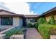 Brick front entry with a paved walkway and mature shrubs at 5345 E Evans Dr, Scottsdale, AZ 85254