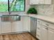 Kitchen with white cabinets, farmhouse sink, and stainless steel dishwasher at 5345 E Evans Dr, Scottsdale, AZ 85254
