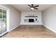 Living room with fireplace, hardwood floors, and sliding glass doors at 5345 E Evans Dr, Scottsdale, AZ 85254