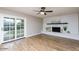 Living room with fireplace, hardwood floors, and sliding glass doors at 5345 E Evans Dr, Scottsdale, AZ 85254