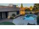 Inviting kidney-shaped pool with a large backyard and landscaping at 5345 E Evans Dr, Scottsdale, AZ 85254