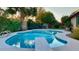 Freeform swimming pool with diving board and surrounding landscaping at 5345 E Evans Dr, Scottsdale, AZ 85254