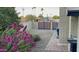 Landscaped side yard with brick pathway and purple flowers at 5345 E Evans Dr, Scottsdale, AZ 85254